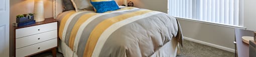 a bedroom with a bed and two windows