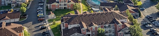 an aerial view of a neighborhood with houses and cars parked