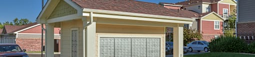 a small white building with a porch and a driveway