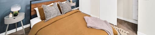 a bedroom with a bed and a ceiling fan