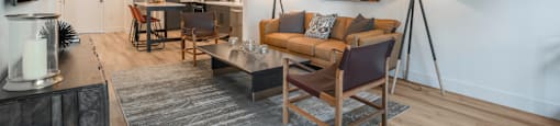 a living room with a couch and chairs and a table
