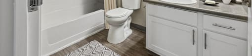 a bathroom with a shower toilet and sink