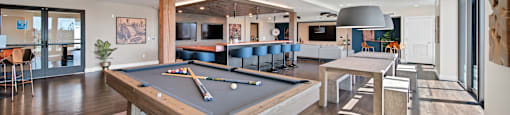 a game room with a pool table and a bar