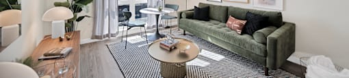 a living room with a green couch and a coffee table