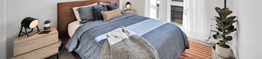 a bedroom with a bed and a large window
