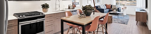 an open kitchen and living room with a table and chairs