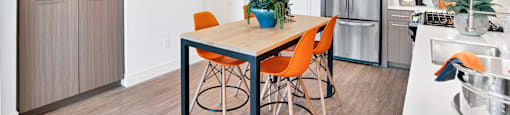 a kitchen and dining room with a table and chairs