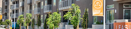 a building with balconies and trees in front of it