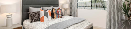 our apartments offer a bedroom with a bed and a large window