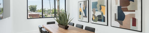 a conference room with a wooden table and black chairs