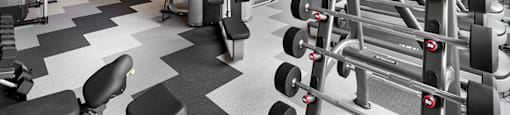 A gym with a variety of equipment including weights and cardio machines.