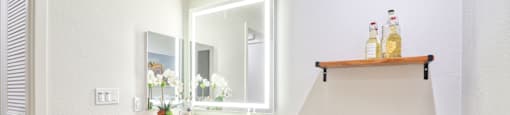 a bathroom with a toilet sink and a mirror