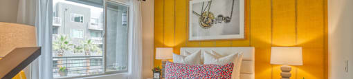 a bedroom with an orange accent wall and a bed