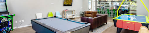 a game room with a pool table and ping pong