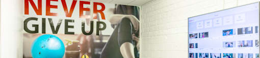 a workout room with weights and a motivational poster on the wall