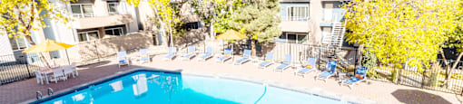 a swimming pool with chairs