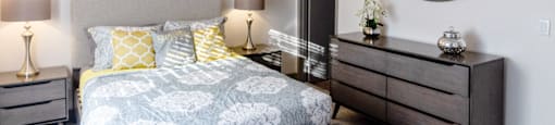 a bedroom with a bed and dresser and a mirror