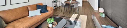 a living room with a brown couch and a table