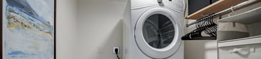 a washer and dryer in a laundry room with a closet