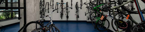 a room full of bikes and a wall with a row of bicycles on it