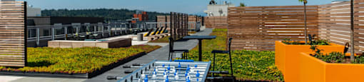 a ping pong table on a rooftop patio with a city in the background