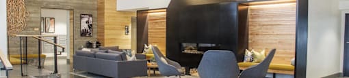 a living room with a fireplace and a table and chairs