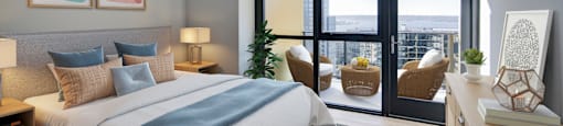 a bedroom with a large bed and a balcony