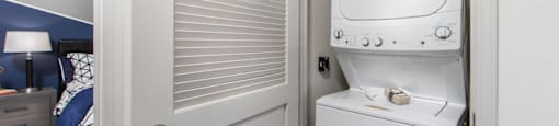 a small laundry room with a washer and dryer on the door