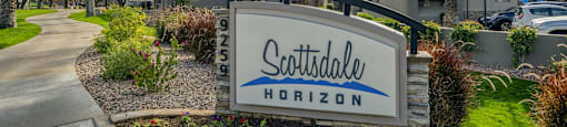 the sign at the entrance of scottsdale hotel on a tree lined street
