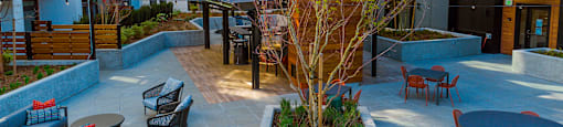 a courtyard with a table and chairs in front of a building