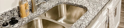 A detailed look at Peachtree Village’s granite countertops and stainless-steel appliances.