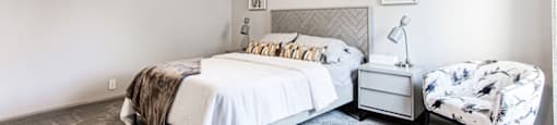 A bedroom with a bed, chair, and ceiling fan.at Laurel, Union City, GA  