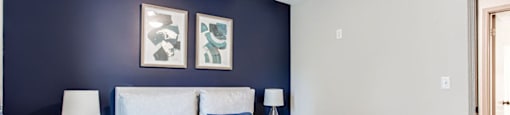 A bedroom with a bed, nightstands, and a ceiling fan.at Laurel, Union City, GA  