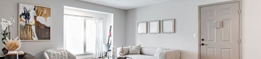 A living room with a brown wooden floor and a white ceiling.at Laurel, Georgia  