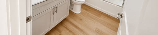 A white bathroom with a toilet, sink, and shower.