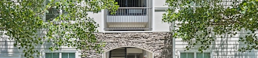 A building with a stone archway entrance and steps leading up to it.