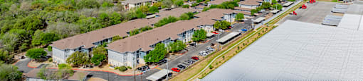 A large industrial area with a building on the right and a parking lot in the middle.