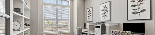 A room with a desk, chair, and a window with blinds.