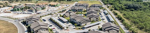 A bird's eye view of a residential area with houses and a road.