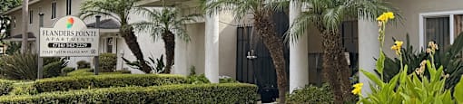 A building with a sign that says Flanders Pointe in front of it.