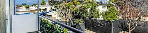 A balcony with a view of a residential area.