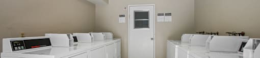 A laundry room with washers and dryers.