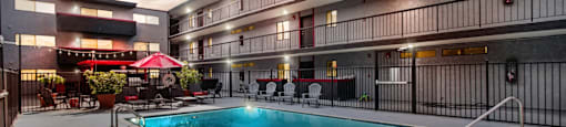A swimming pool in a courtyard surrounded by apartment buildings.