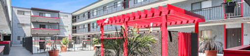 A red canopy is over a seating area.