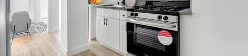 A modern kitchen with a stove and oven built into the wall.