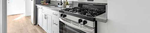 A modern kitchen with a black stove top oven.