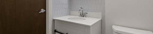 Bathroom with sink and mirror in a 1-bedroom, 1-bath senior apartment at Northwood Apartments in Franklin.