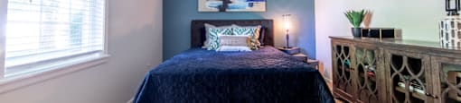 Spacious bedroom with a window at Ashton Brook Apartments