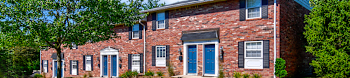 Exterior view of Ashton Brook Apartments, showcasing the building's architecture and surrounding landscaping.