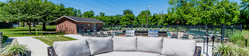 Fire pit with outdoor seating at Ashton Brook Apartments, providing a cozy space for relaxation.